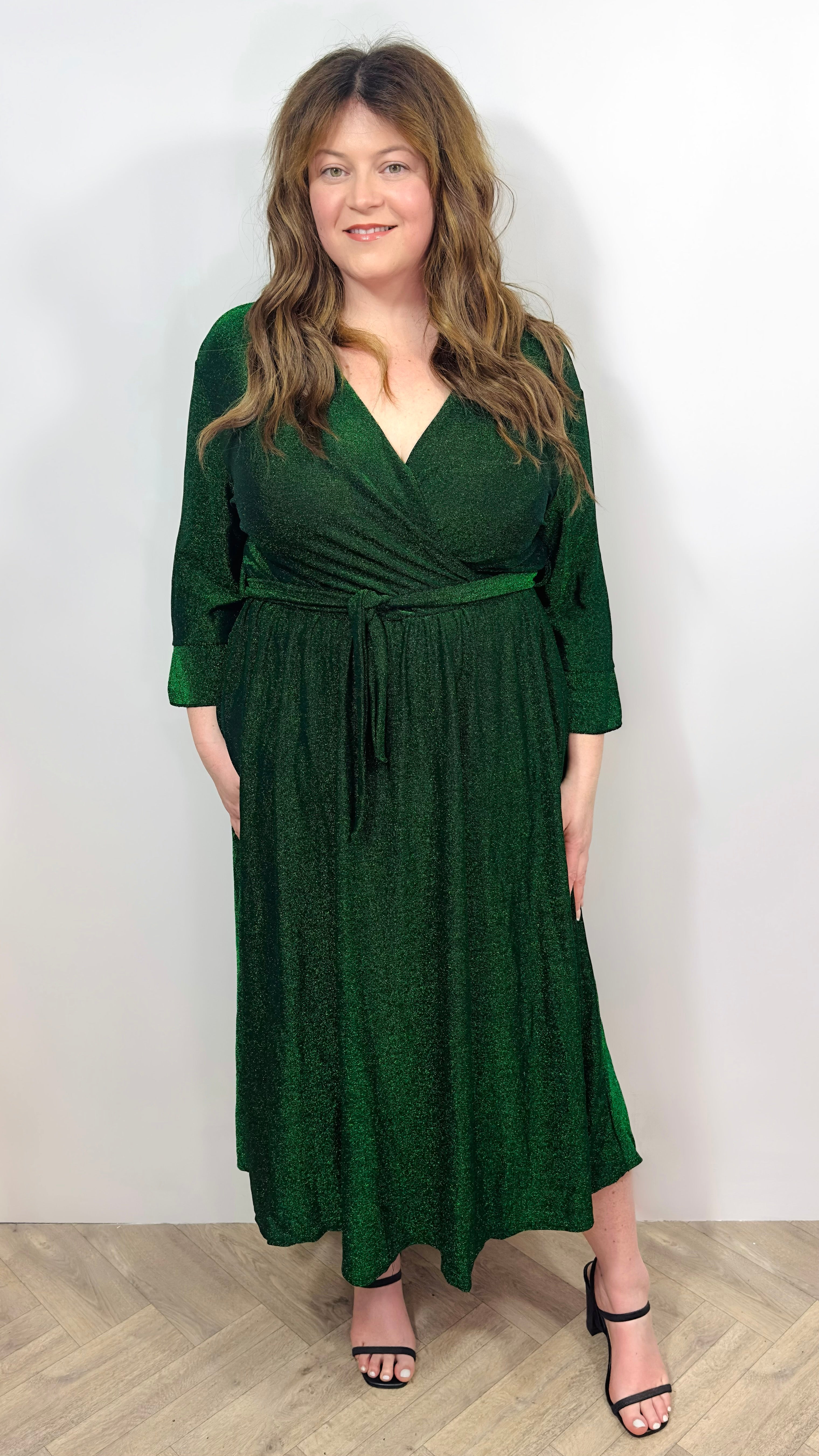 Woman wearing a green dress on a white background