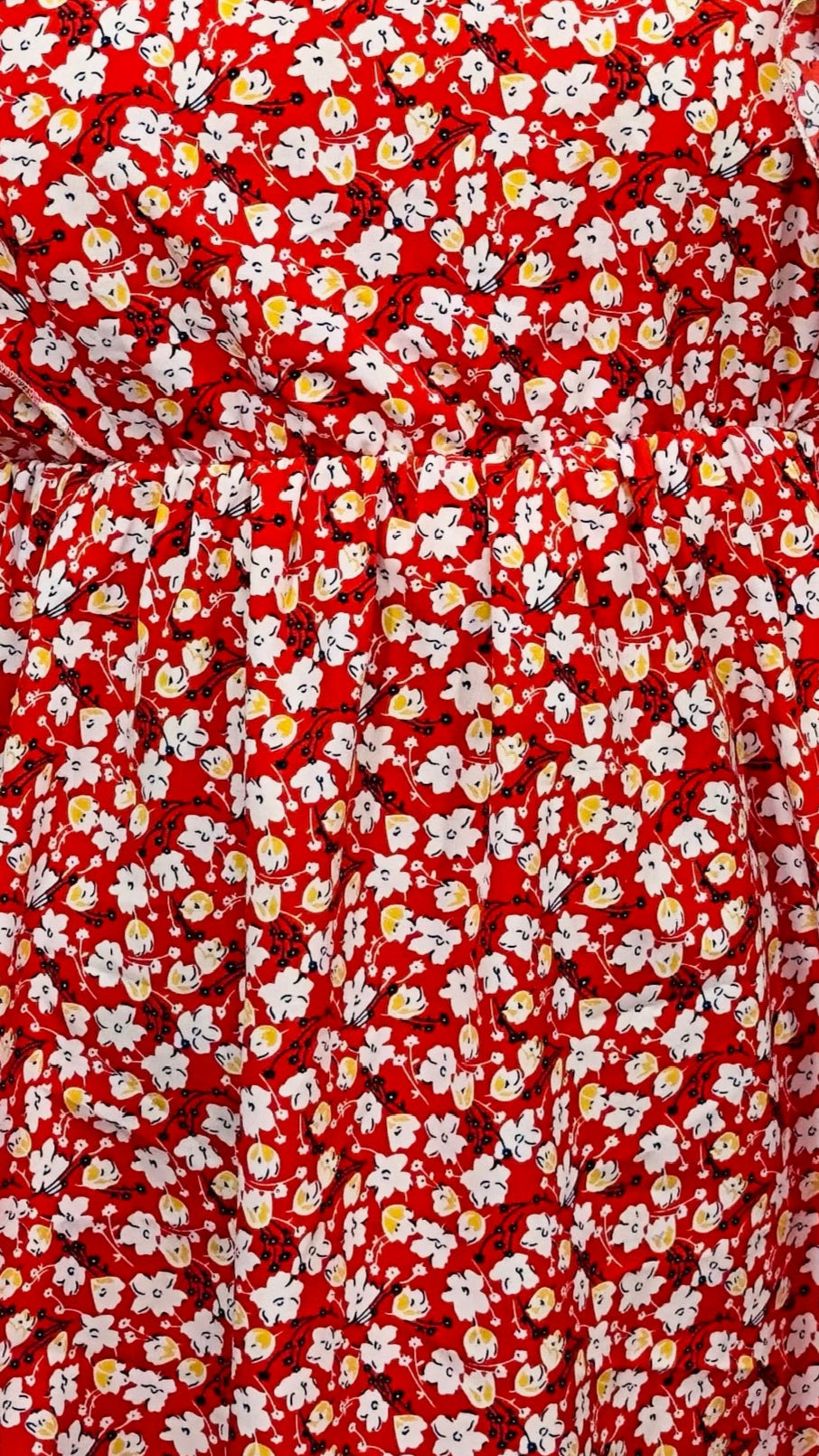 Red fabric with small white floral pattern