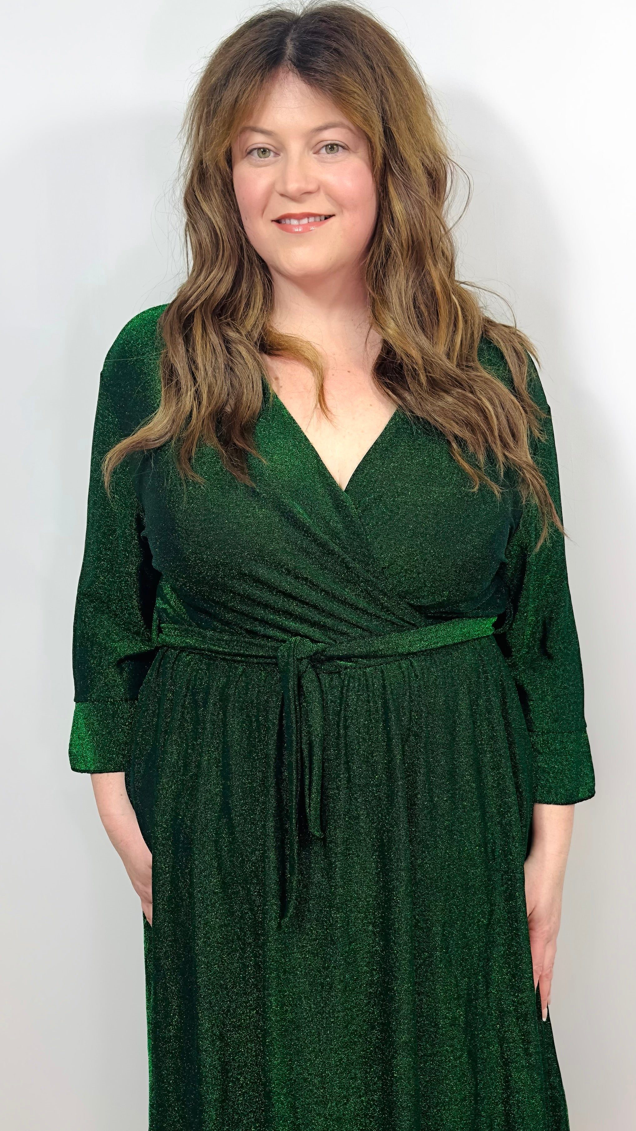 Woman wearing a green dress on a white background