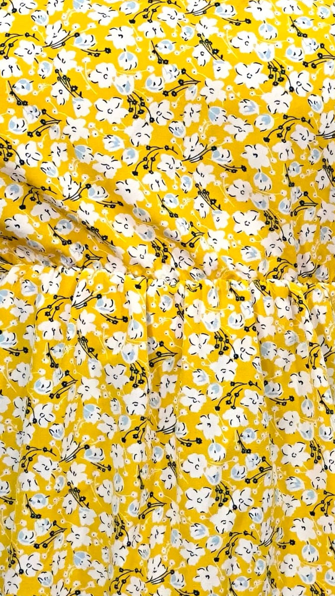 Floral pattern with white flowers and black stems on a yellow background