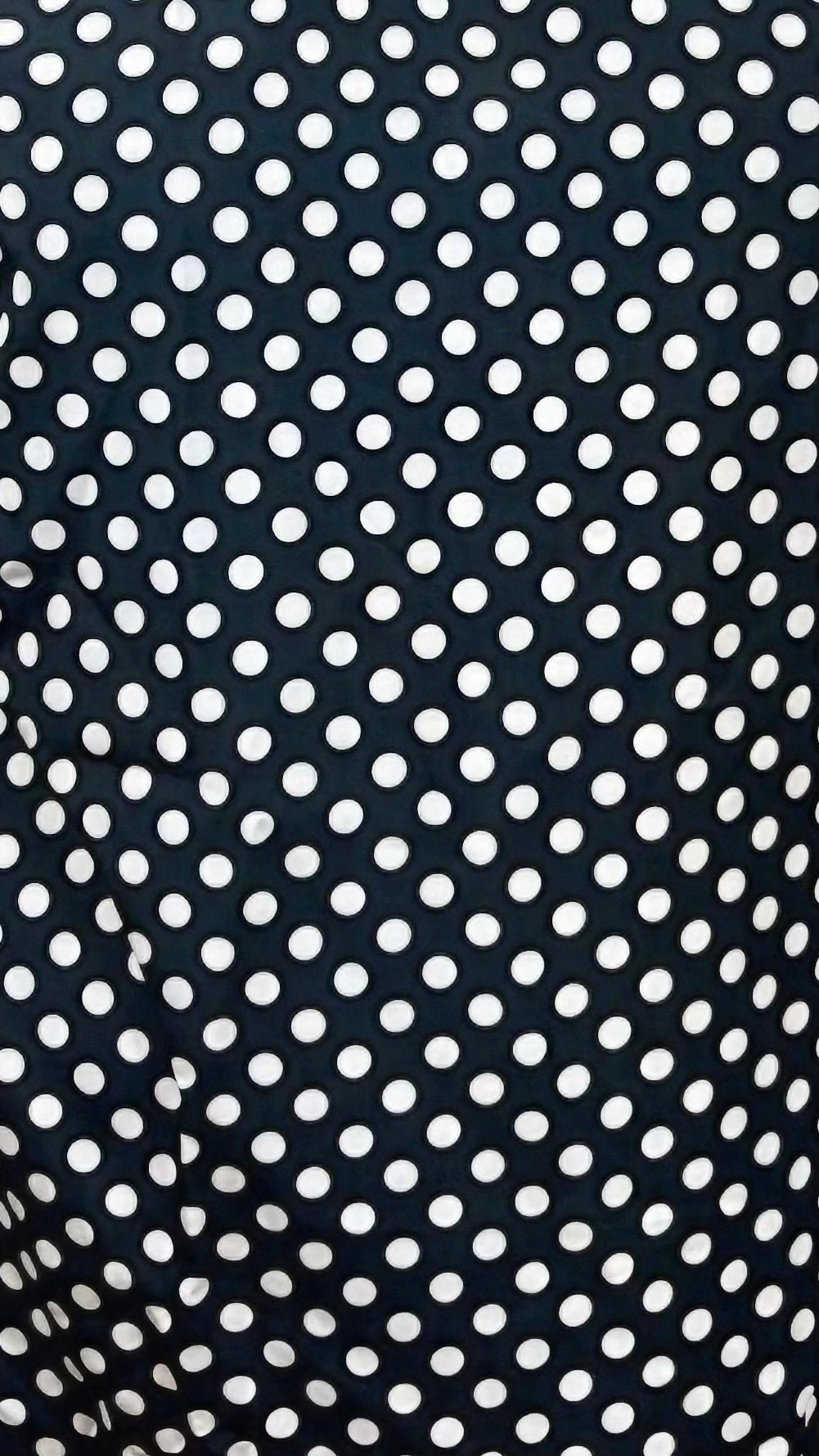 Black fabric with white polka dot pattern