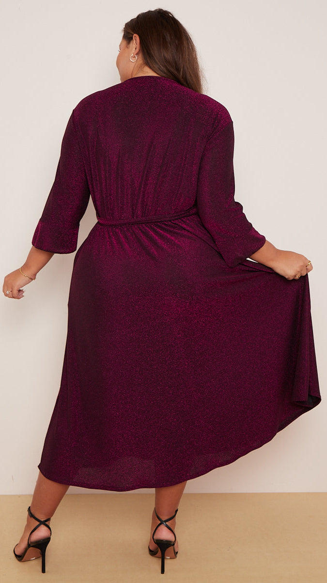 Woman wearing a burgundy dress against a white background